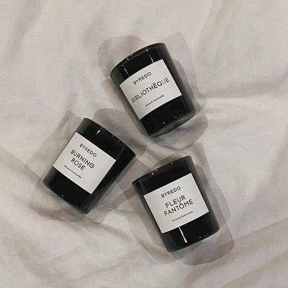 3 pcs of Byredo scented candles lying.